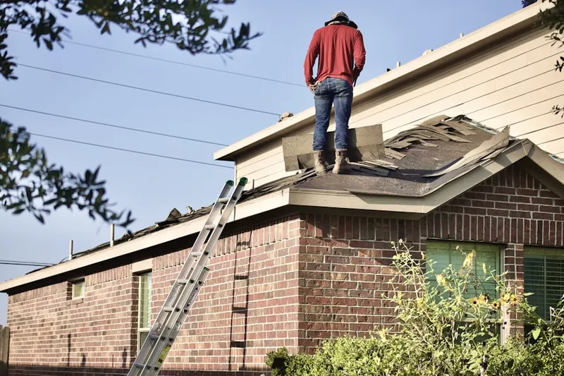 Professional roofer working on a residential roof in Morlan Park